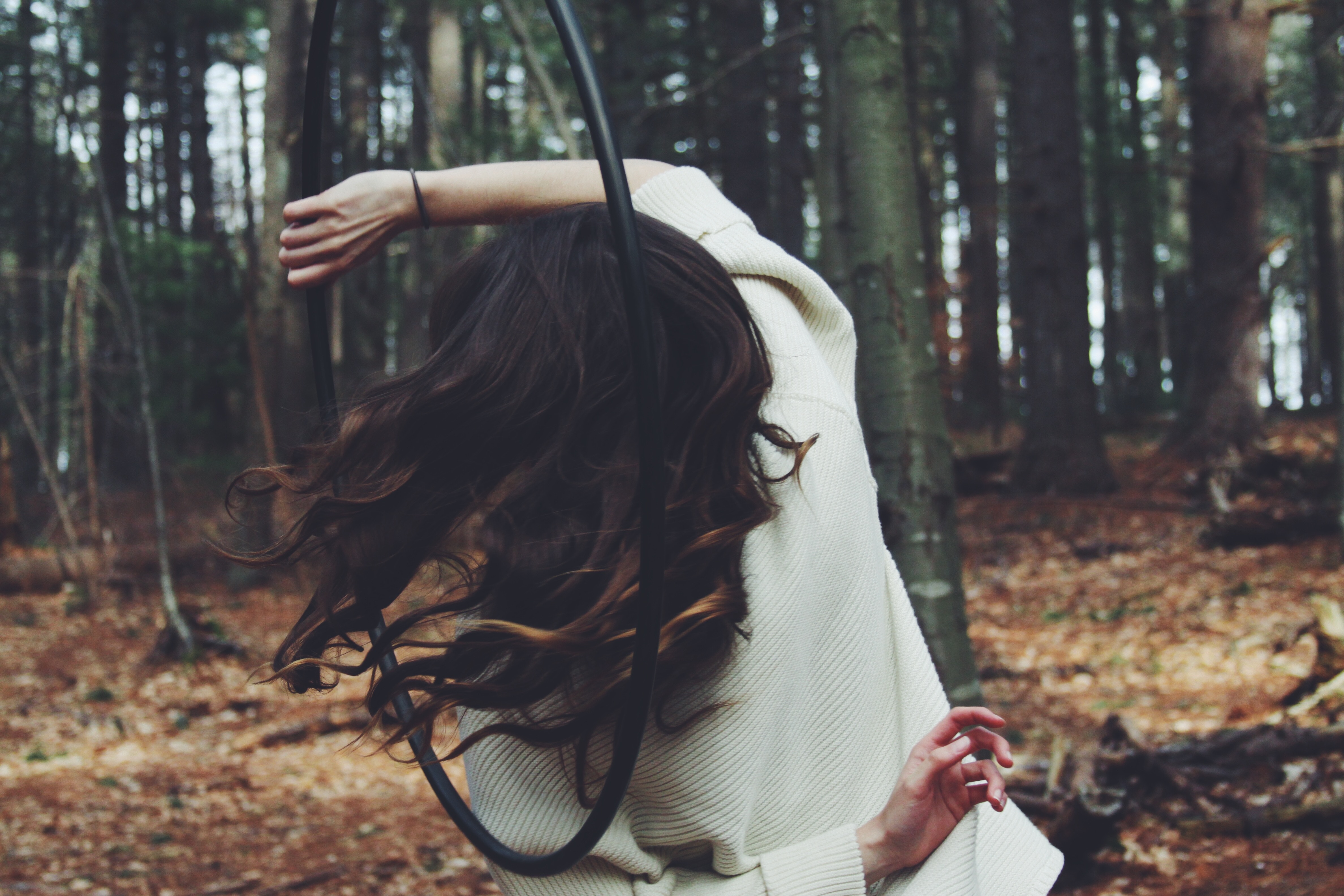 girl hooping in forest